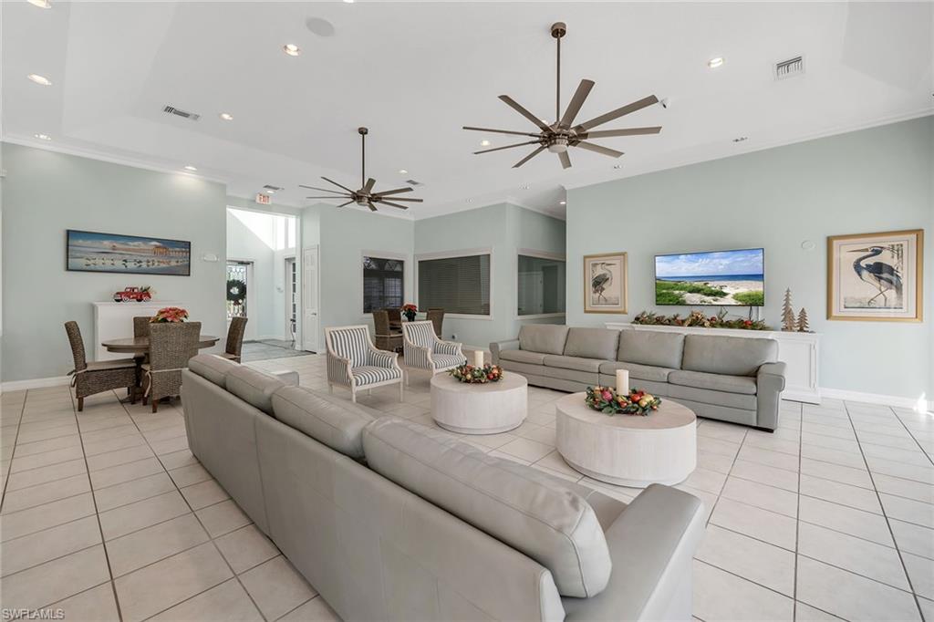 4620 St Croix Lane, Unit 918 Naples, FL 34109 - Photo 31 of 43 a living room with furniture and a chandelier