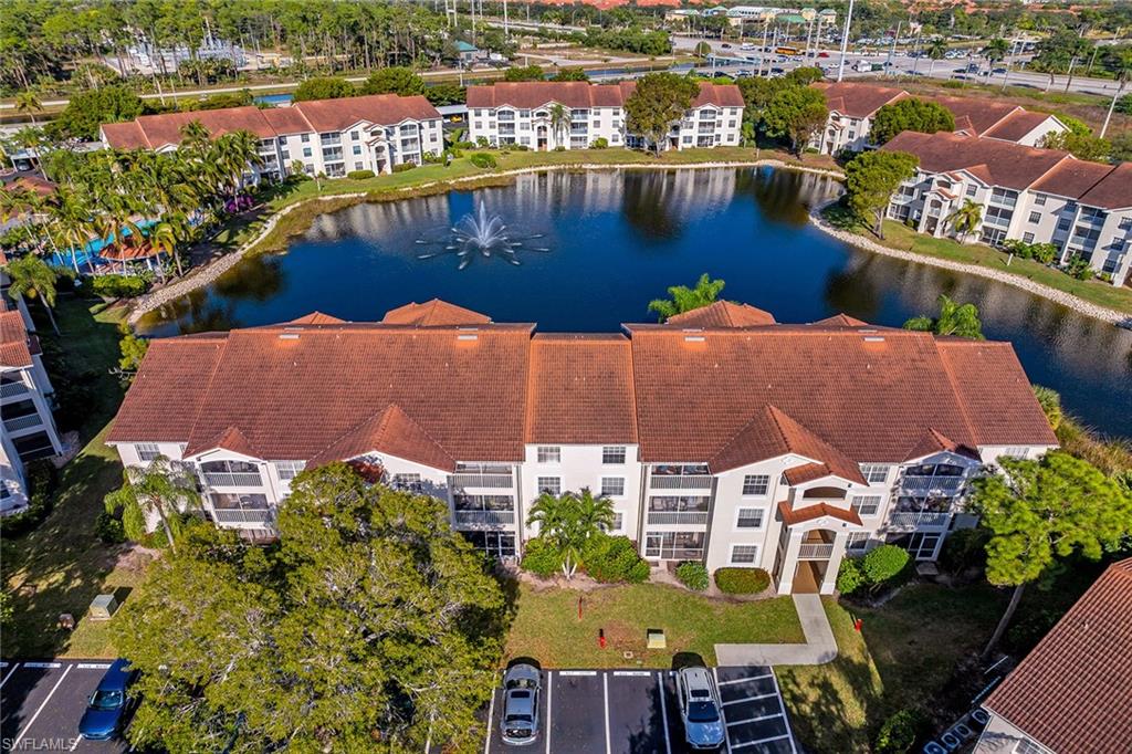 4620 St Croix Lane, Unit 918 Naples, FL 34109 - Photo 36 of 43 an aerial view of residential houses with outdoor space and lake view