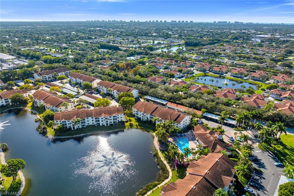 4620 St Croix Lane, Unit 918 Naples, FL 34109 - Photo 38 of 43 an aerial view of residential houses with outdoor space and lake view