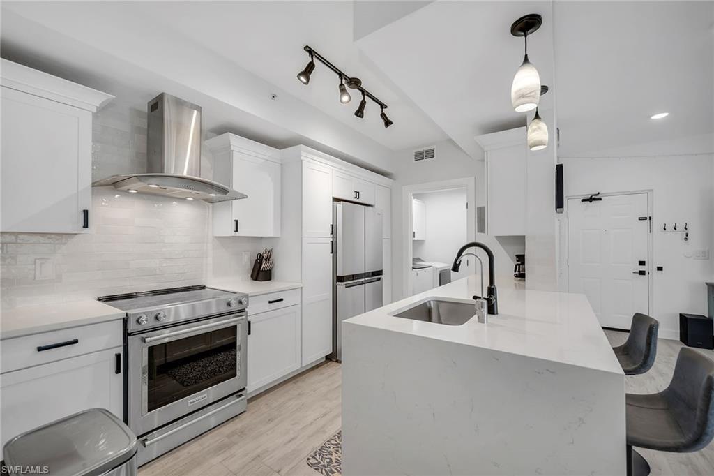 4620 St Croix Lane, Unit 918 Naples, FL 34109 - Photo 7 of 43 a kitchen with stainless steel appliances granite countertop a sink stove and refrigerator