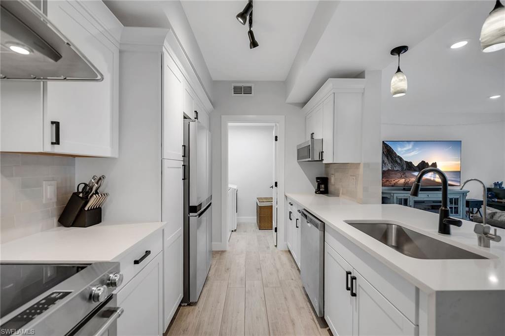 4620 St Croix Lane, Unit 918 Naples, FL 34109 - Photo 8 of 43 a kitchen with a sink and refrigerator