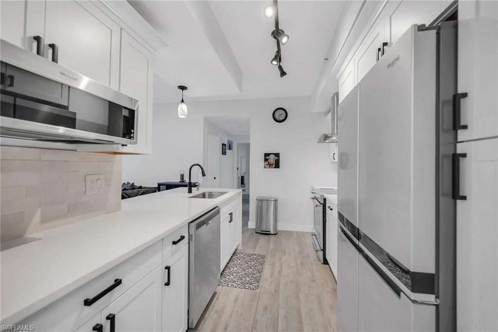 4620 St Croix Lane, Unit 918 Naples, FL 34109 - Photo 9 of 43 a kitchen with a sink and refrigerator