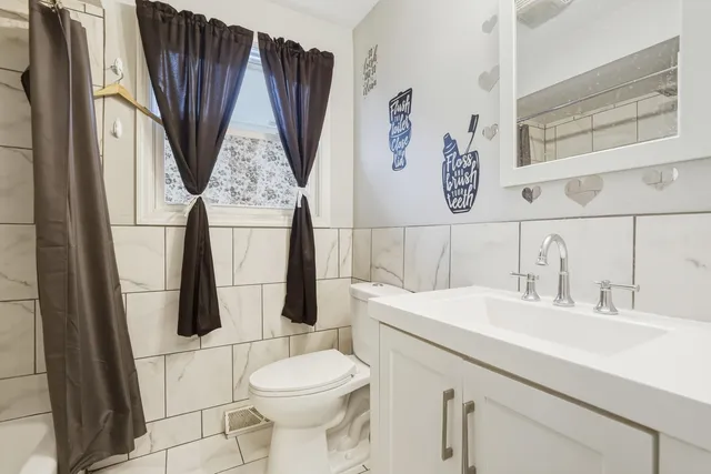 a bathroom with a sink a toilet and a mirror