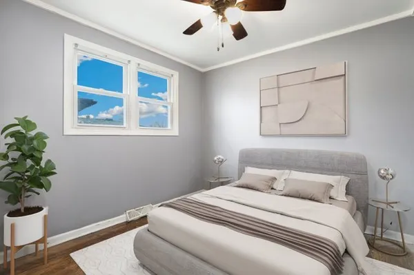 a bedroom with a bed and a potted plant