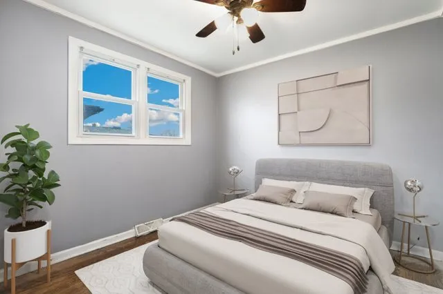 a bedroom with a bed and a potted plant