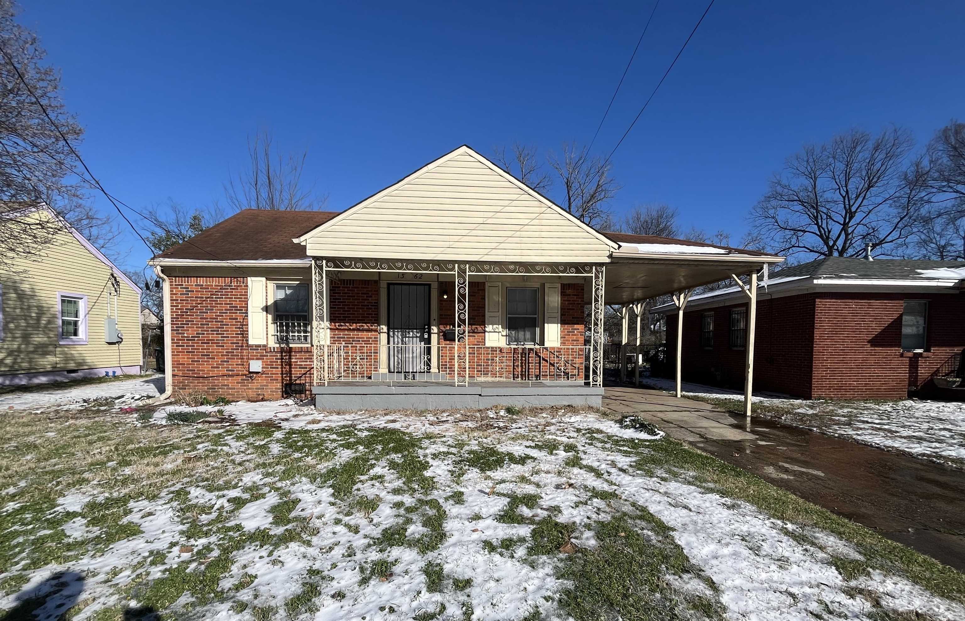 1362 Springdale Street Memphis, TN 38108 - Photo 1 of 16 a front view of a house with a garden and patio
