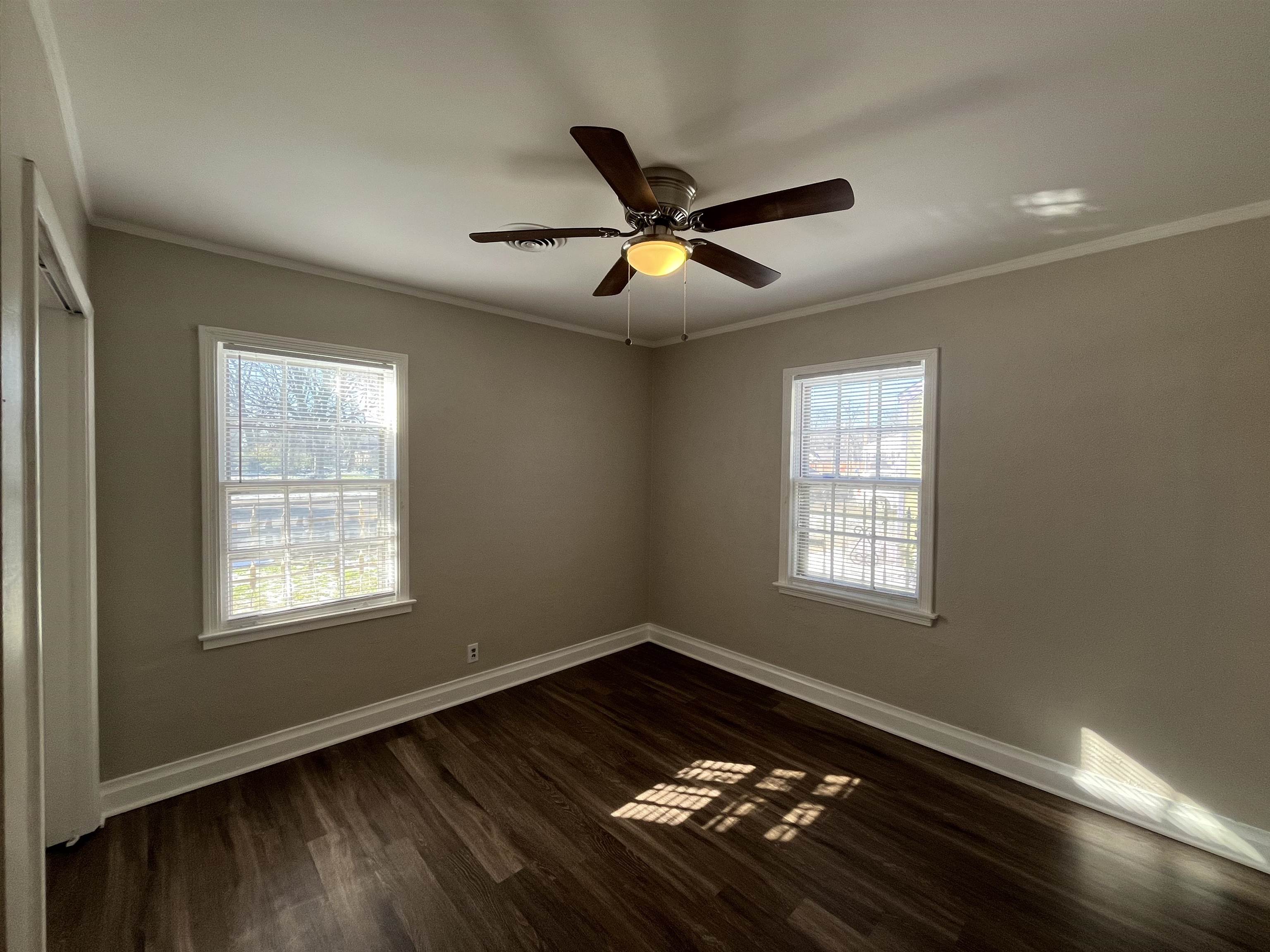 1362 Springdale Street Memphis, TN 38108 - Photo 11 of 16 a view of an empty room with a window and wooden floor