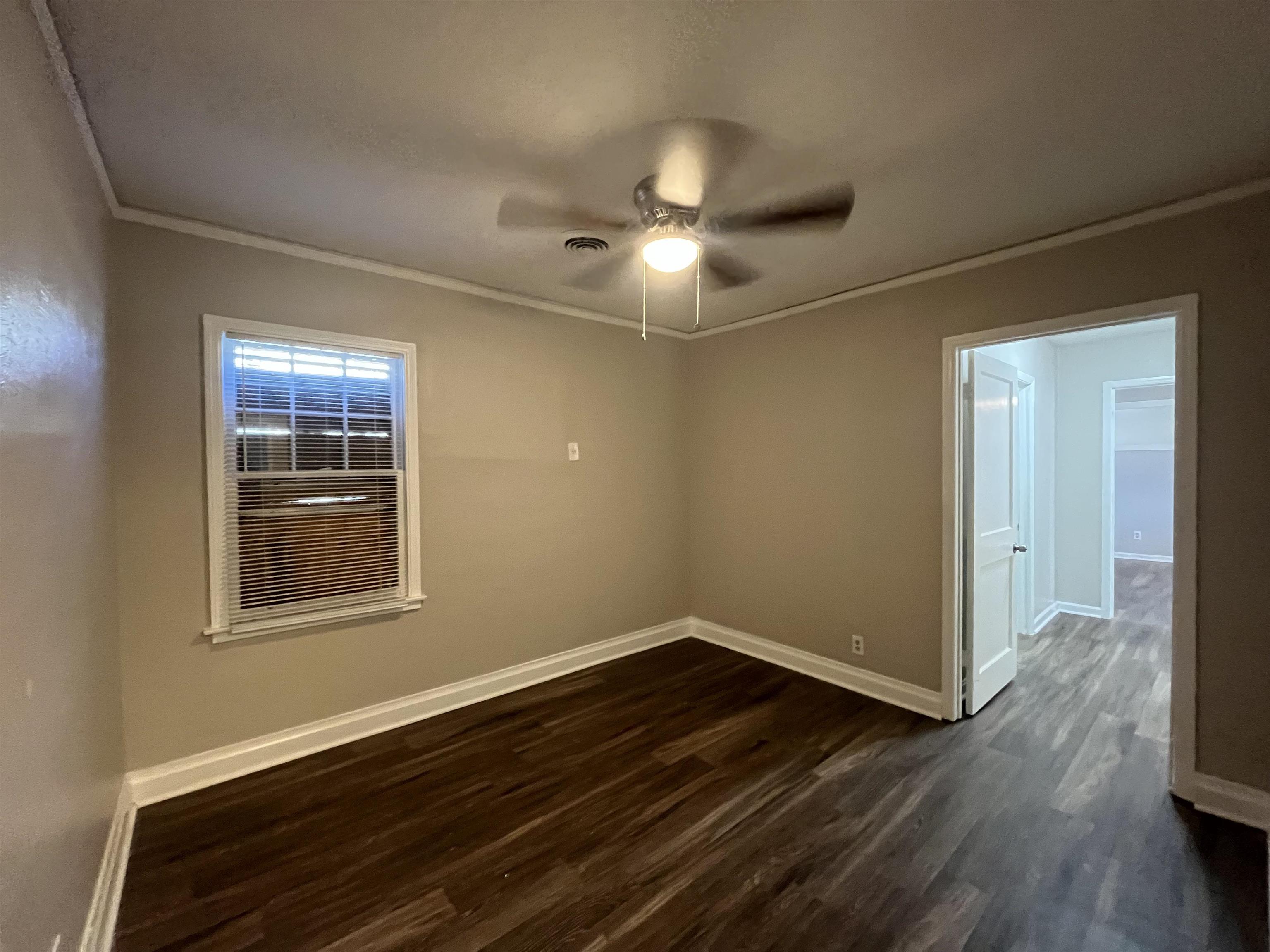 1362 Springdale Street Memphis, TN 38108 - Photo 12 of 16 a view of an empty room with wooden floor and a window