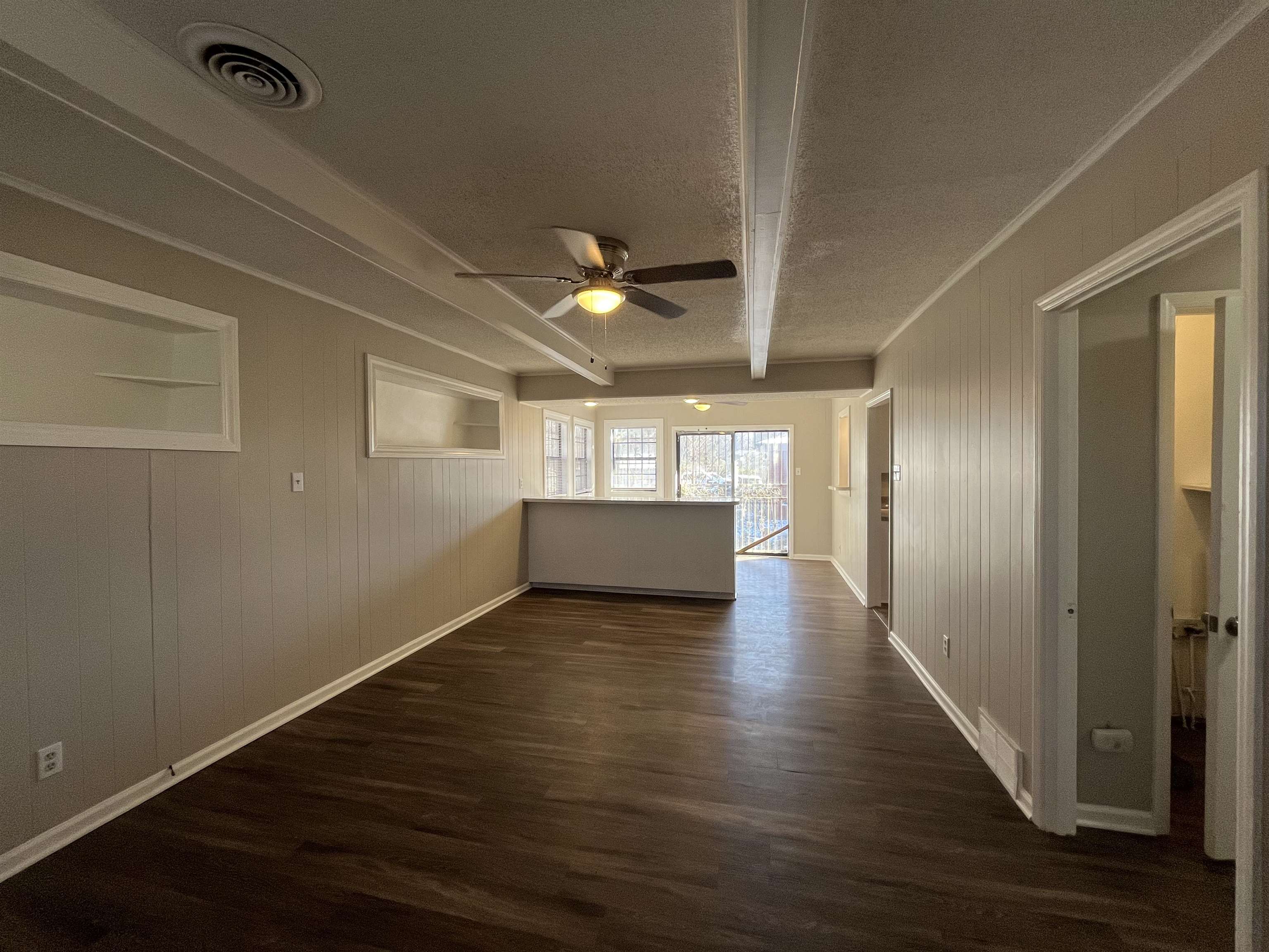 1362 Springdale Street Memphis, TN 38108 - Photo 16 of 16 a view of an empty room with wooden floor and a window