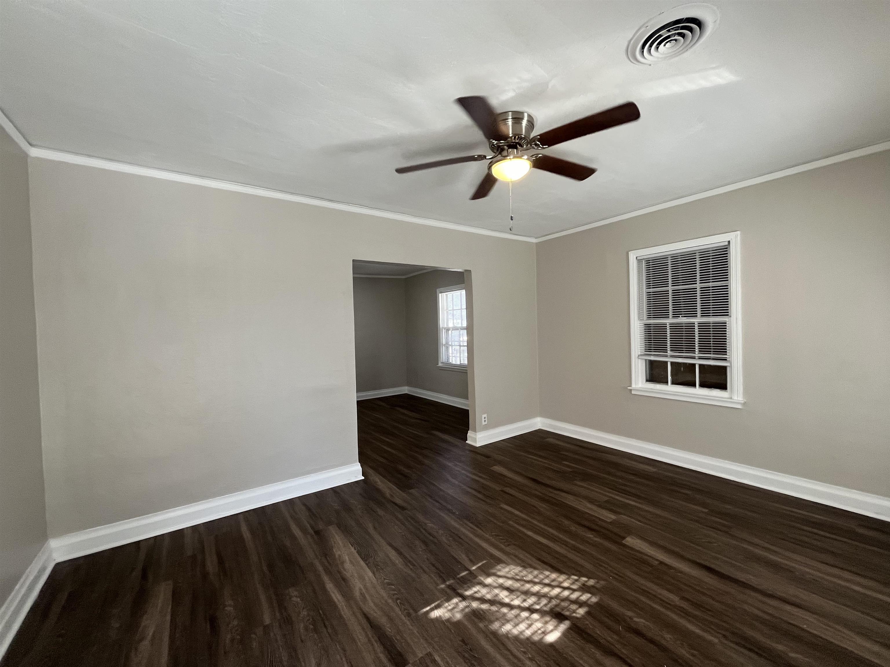 1362 Springdale Street Memphis, TN 38108 - Photo 2 of 16 a view of an empty room with wooden floor and a window