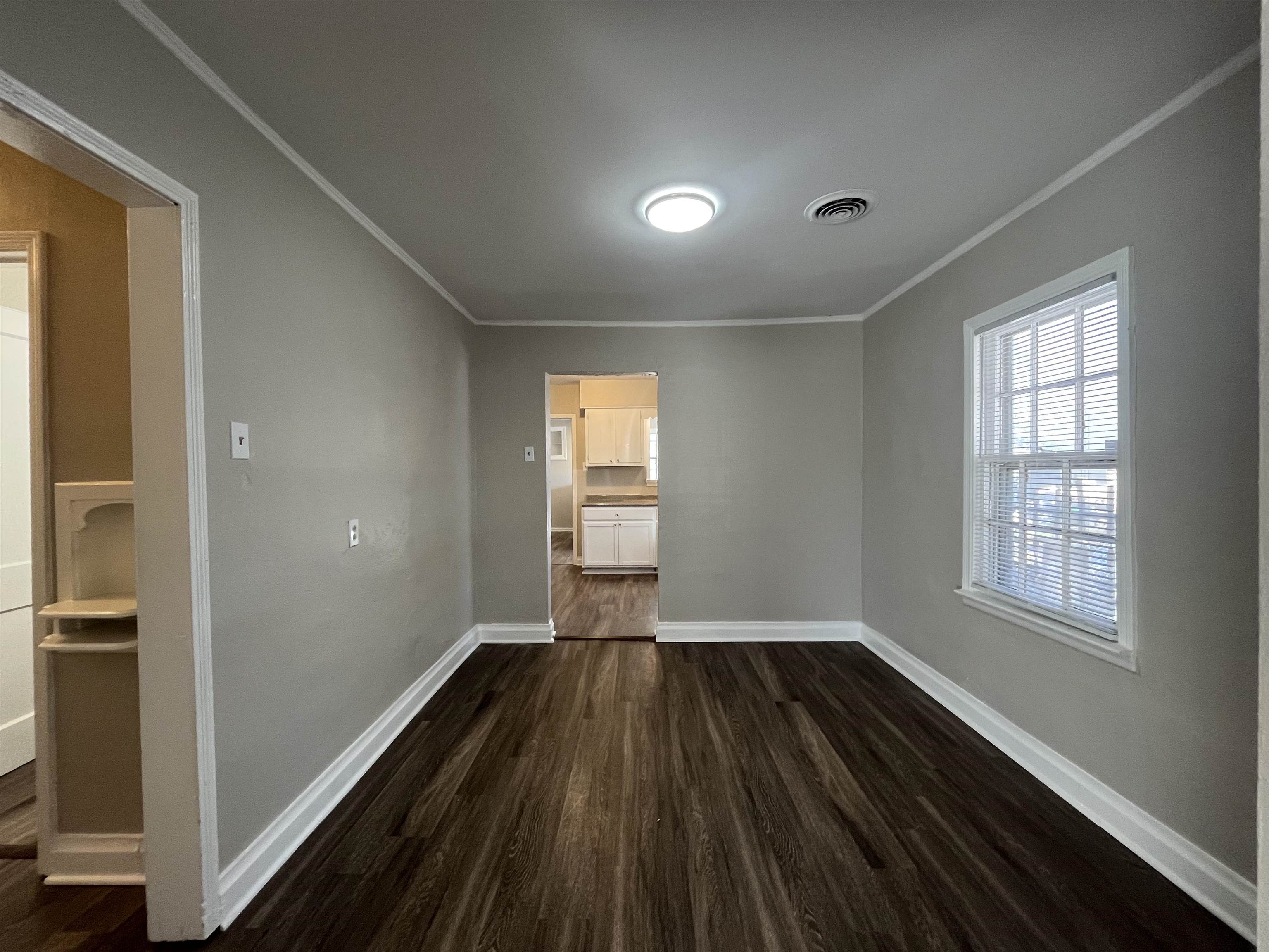 1362 Springdale Street Memphis, TN 38108 - Photo 3 of 16 a view of empty room with wooden floor and fan