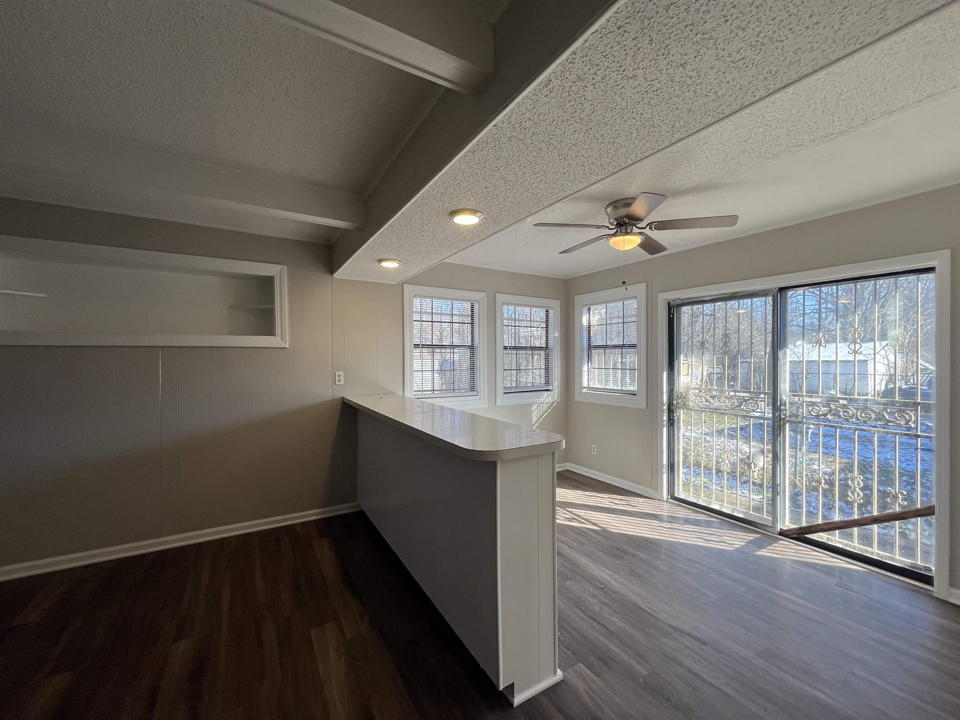 1362 Springdale Street Memphis, TN 38108 - Photo 6 of 16 a view of an empty room with wooden floor and a window