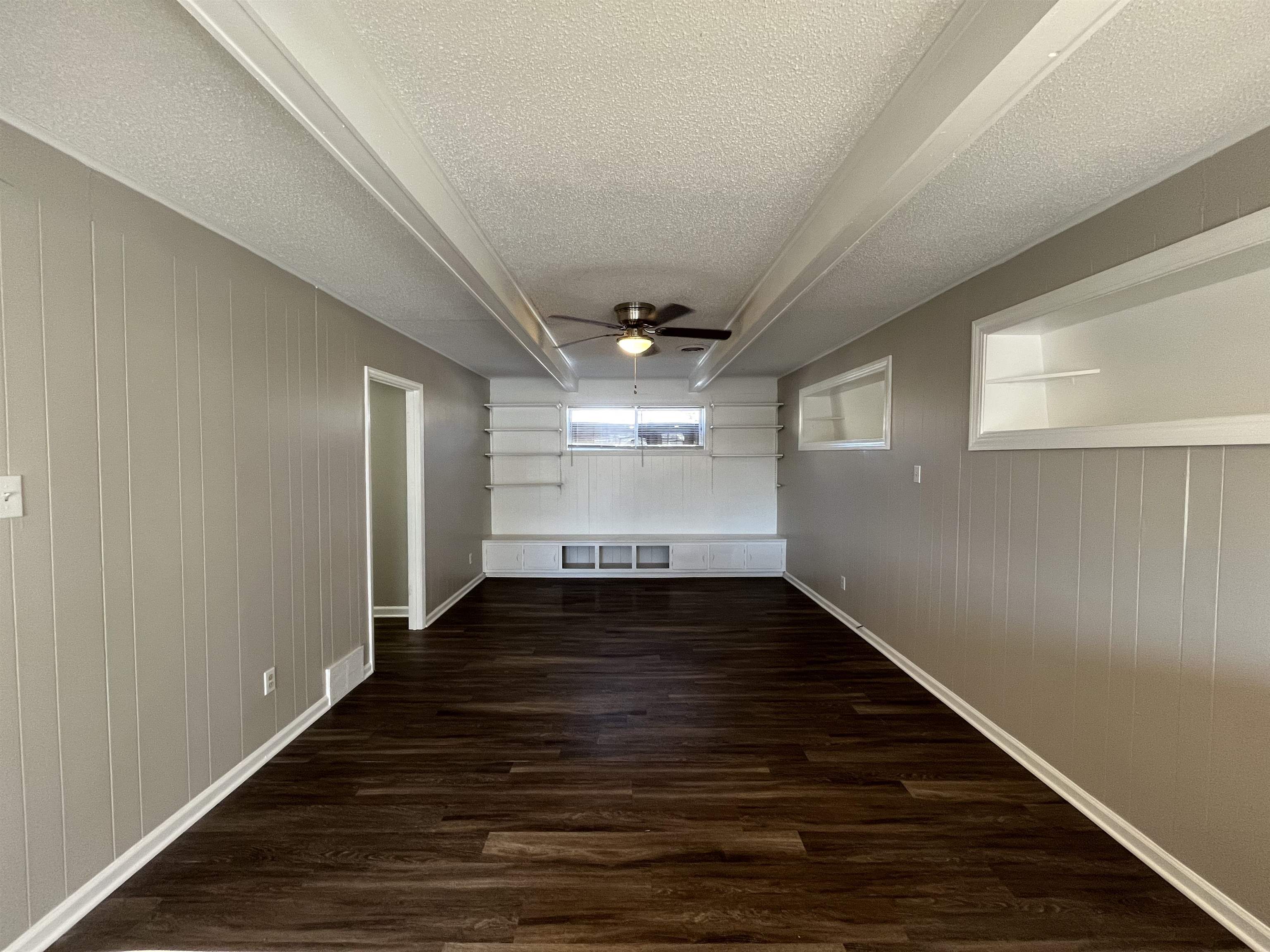 1362 Springdale Street Memphis, TN 38108 - Photo 7 of 16 a view of an empty room with wooden floor and a window