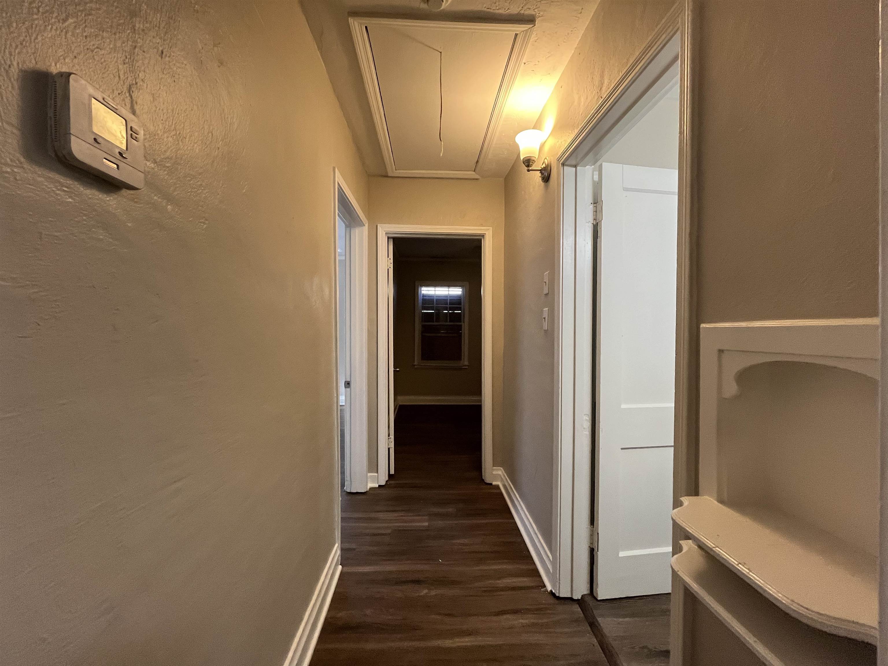 1362 Springdale Street Memphis, TN 38108 - Photo 8 of 16 a view of a hallway with wooden floor and staircase