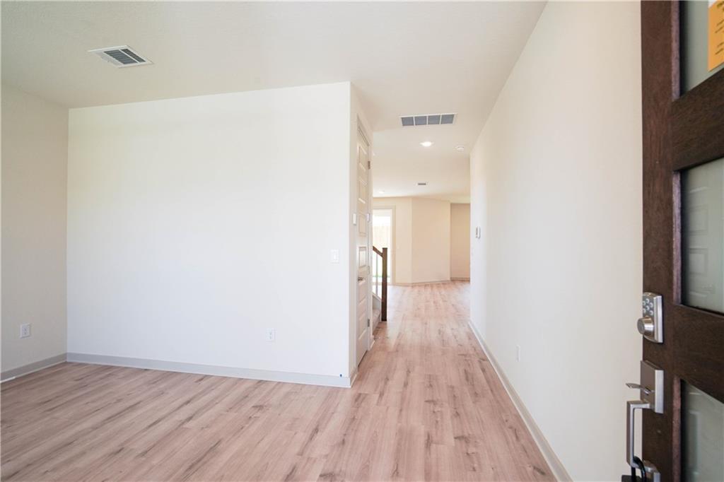 2341 Gabriels Horn Road Leander, TX 78641 - Photo 3 of 20 Corridor with light wood-style floors, recessed lighting, and stairs