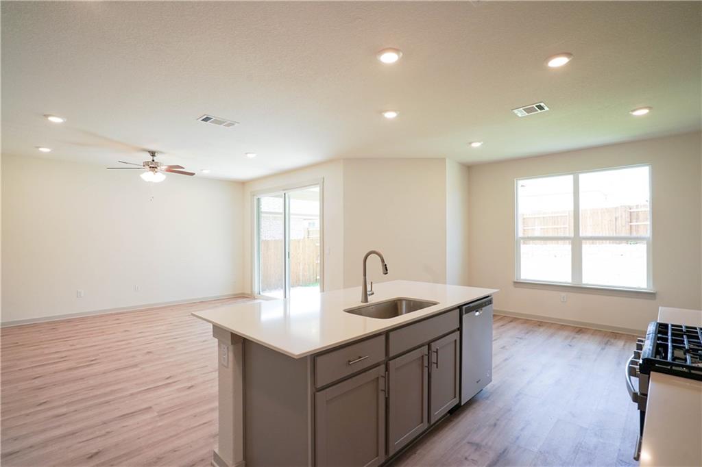 2341 Gabriels Horn Road Leander, TX 78641 - Photo 20 of 20 Kitchen with open floor plan, an island with sink, light wood-type flooring, recessed lighting, and appliances with stainless steel finishes