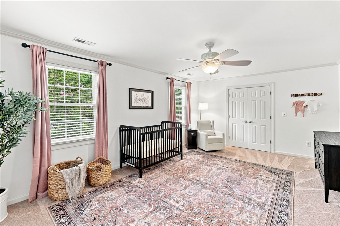 320 Watson Road Easley, SC 29642 - Photo 26 of 50 Crown molding and soft carpeting elevate this cozy bedroom space.