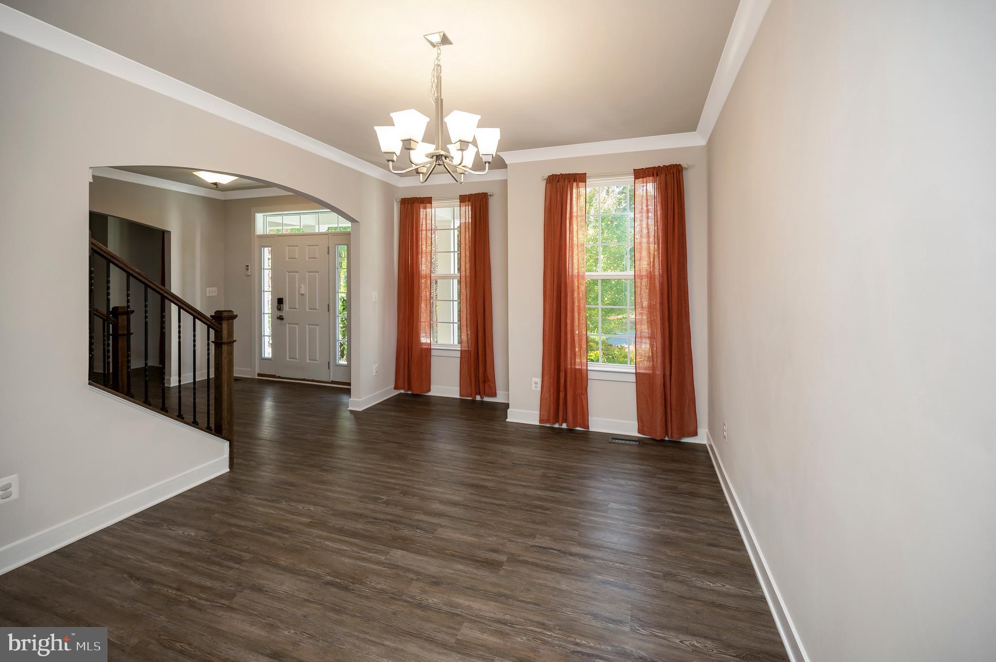 34 Oak Road Stafford, VA 22556 - Photo 13 of 39 a view of a hallway with wooden floor and chandelier