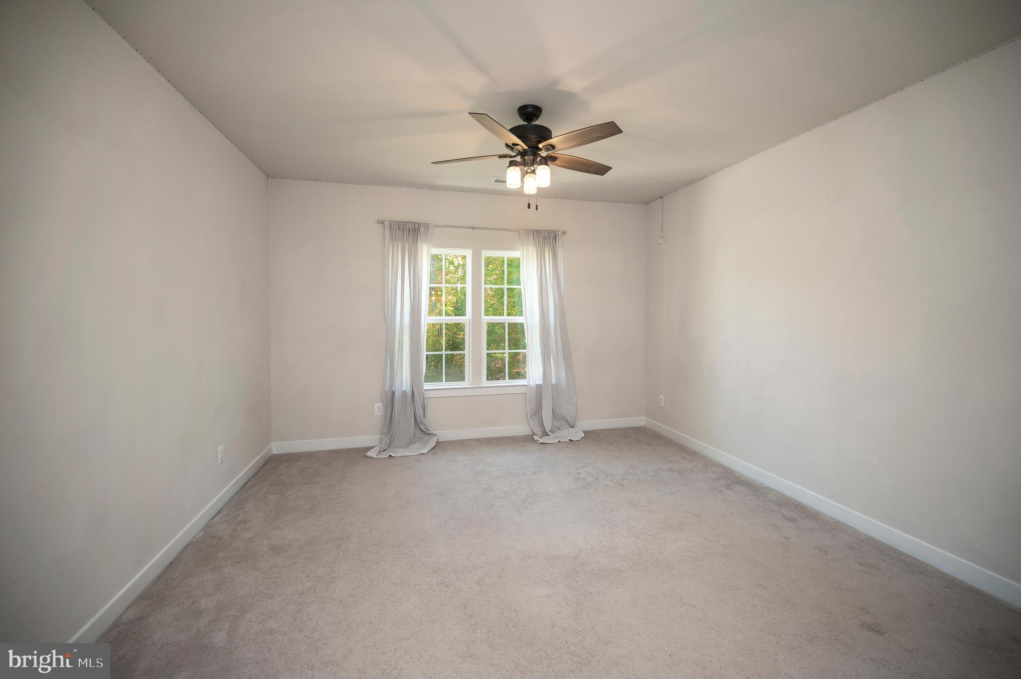 34 Oak Road Stafford, VA 22556 - Photo 16 of 39 an empty room with chandelier fan and windows