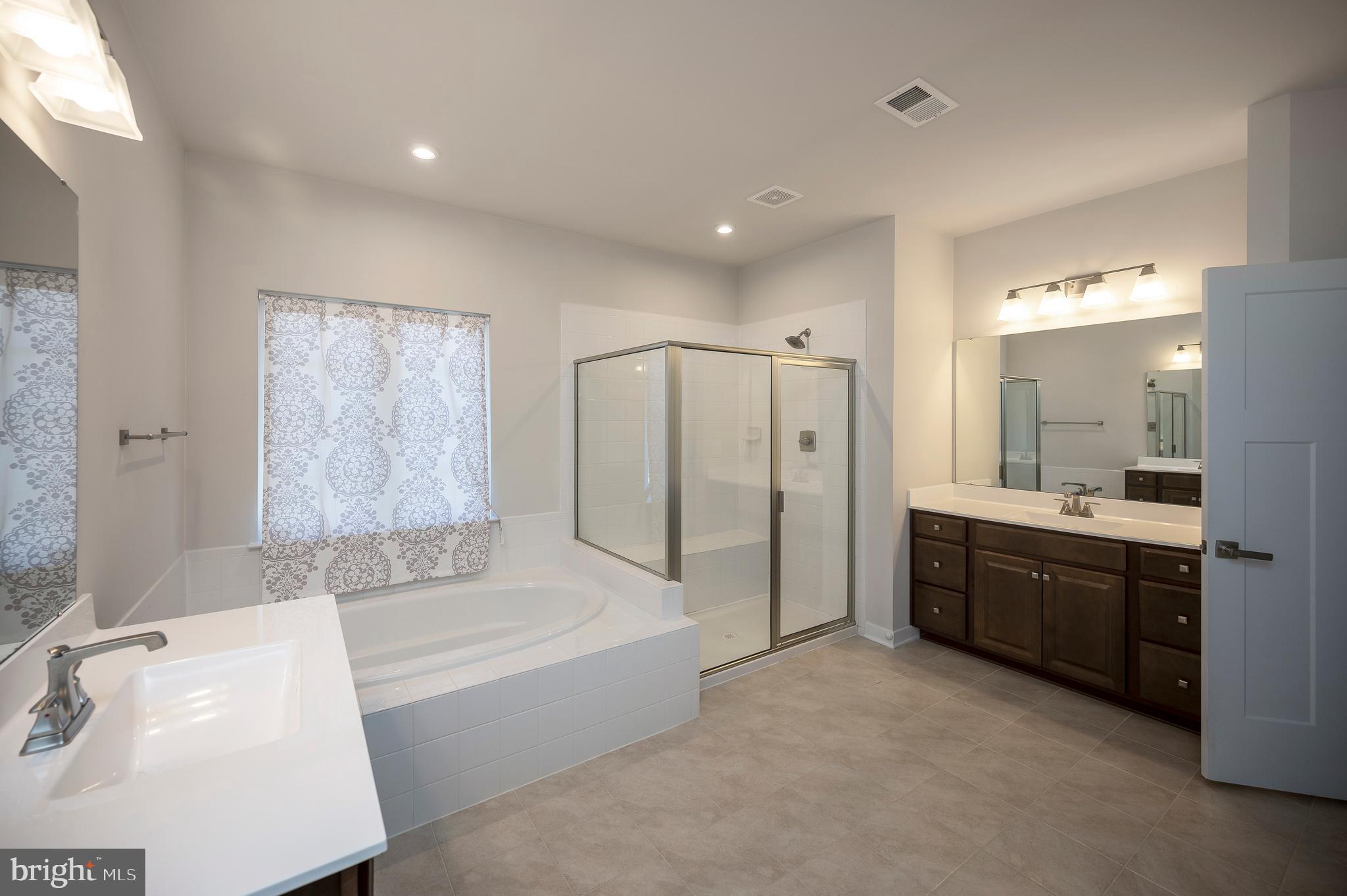 34 Oak Road Stafford, VA 22556 - Photo 26 of 39 a large spacious bathroom with a tub sink shower and mirror