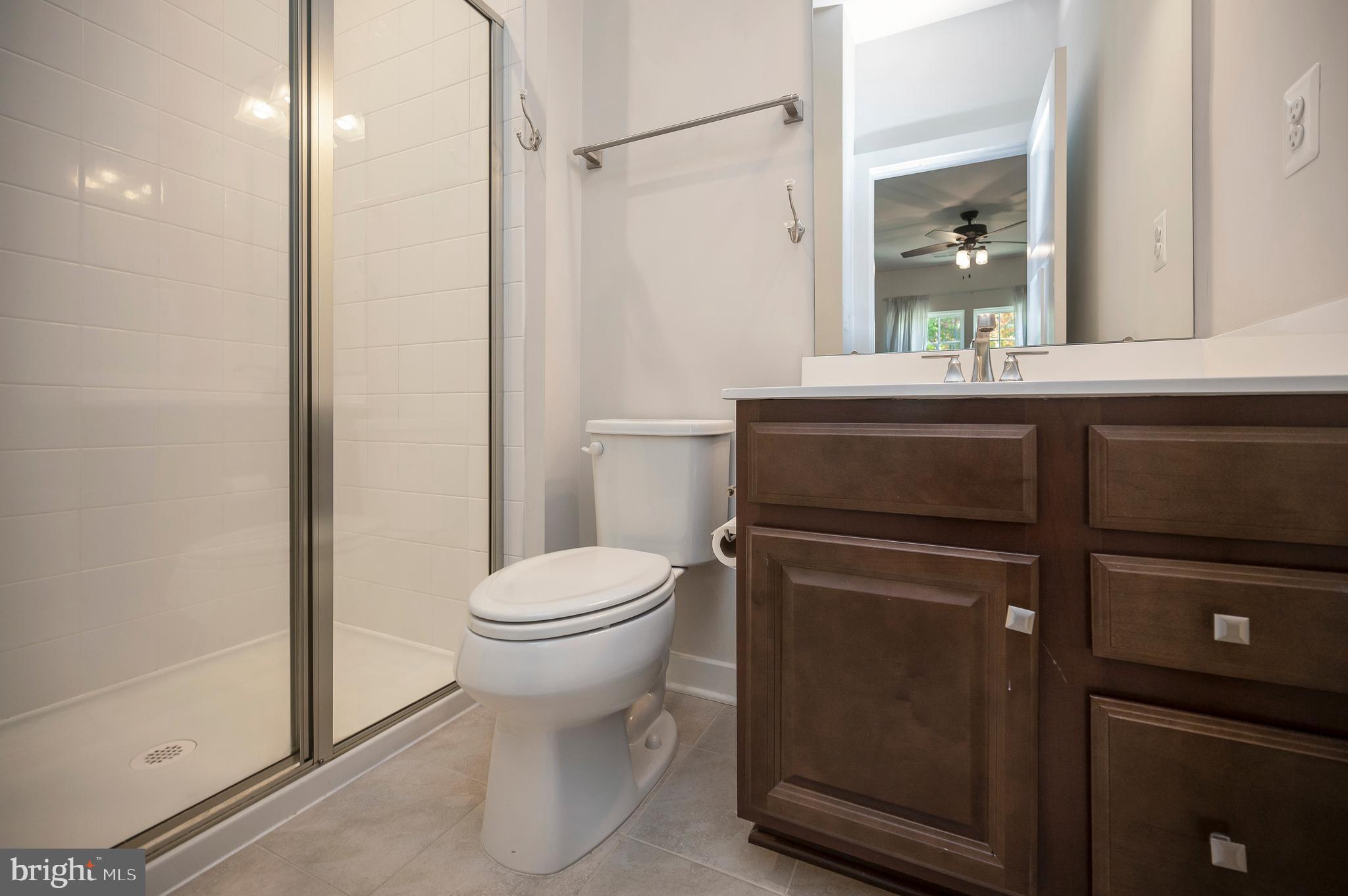 34 Oak Road Stafford, VA 22556 - Photo 33 of 39 a bathroom with a toilet a sink and shower