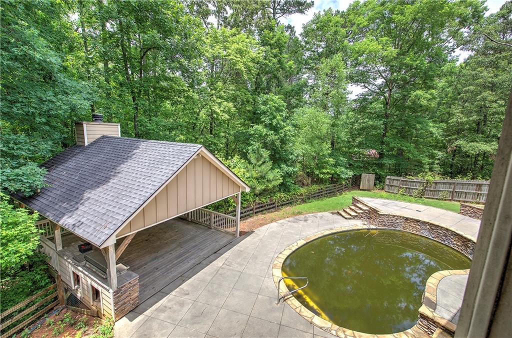 561 Holland Road Dallas, GA 30157 - Photo 17 of 48 a view of a swimming pool with a patio and plants