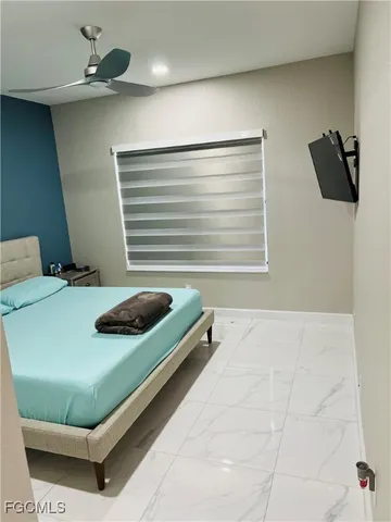 a bedroom with a bed and window