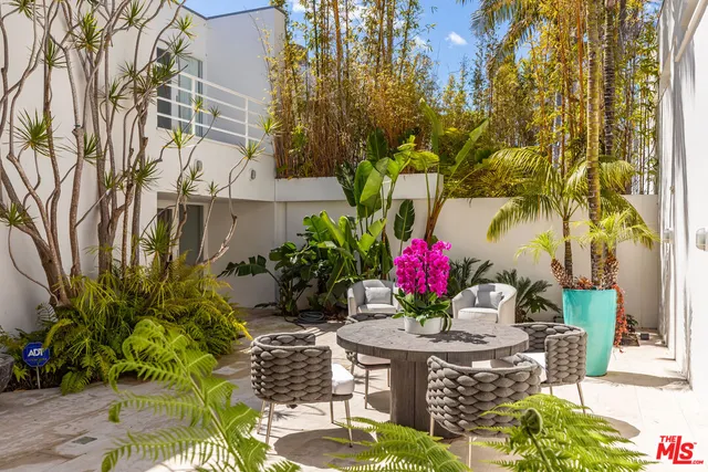 a view of a tables and chair and potted plants