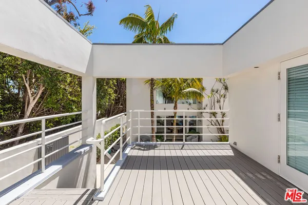 a view of a balcony with wooden floor