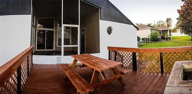 a view of a roof deck with wooden floor and fence
