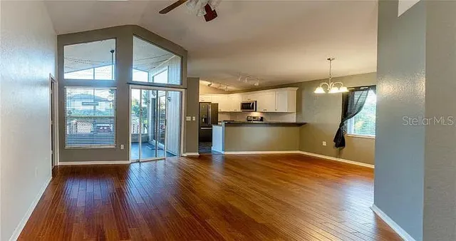a view of a kitchen with wooden floor and a kitchen