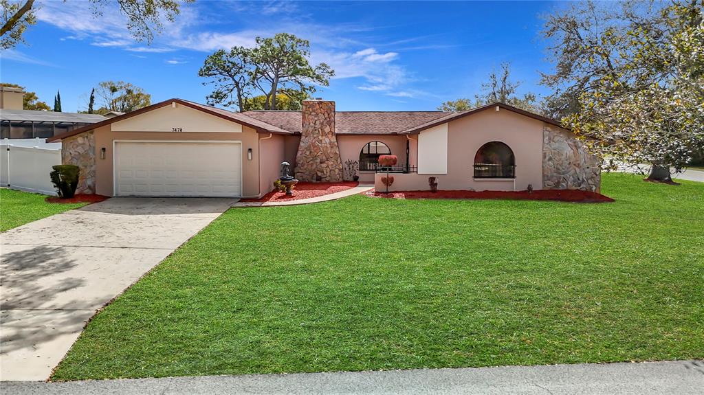 7478 Dundee Way Weeki Wachee, FL 34613 - Photo 1 of 52 a view of a house with a yard