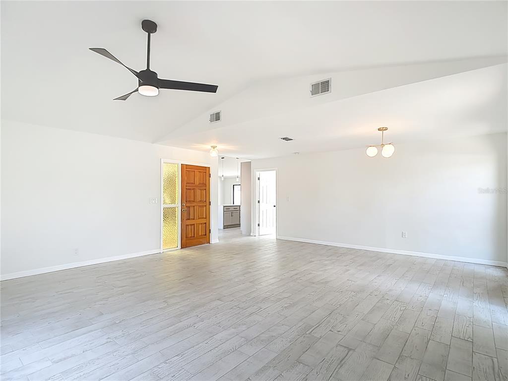 7478 Dundee Way Weeki Wachee, FL 34613 - Photo 11 of 52 a view of empty room with wooden floor and fan