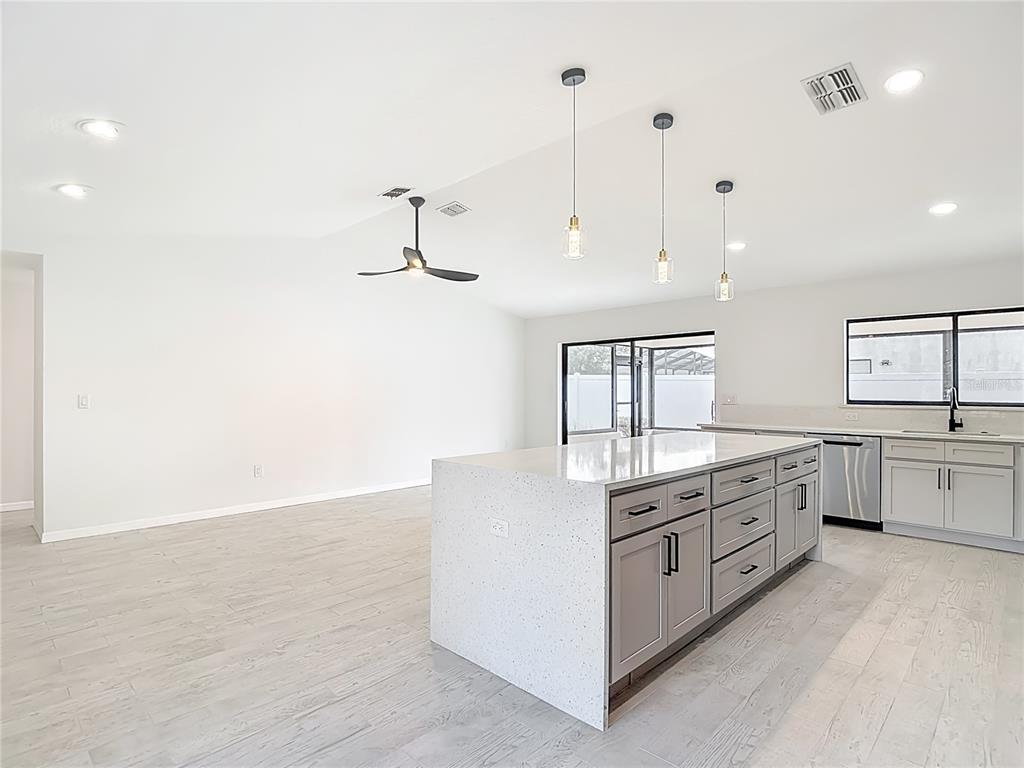 7478 Dundee Way Weeki Wachee, FL 34613 - Photo 14 of 52 a kitchen with white cabinets and sink