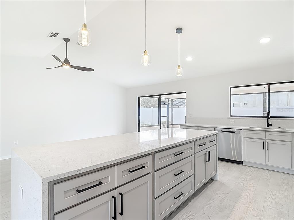7478 Dundee Way Weeki Wachee, FL 34613 - Photo 15 of 52 a spacious bathroom with a granite countertop sink a mirror and a