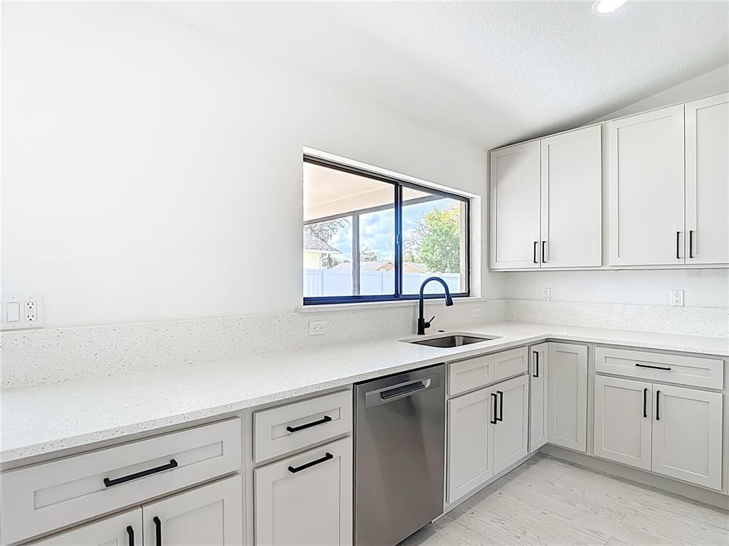 7478 Dundee Way Weeki Wachee, FL 34613 - Photo 21 of 52 a kitchen with a sink cabinets and window