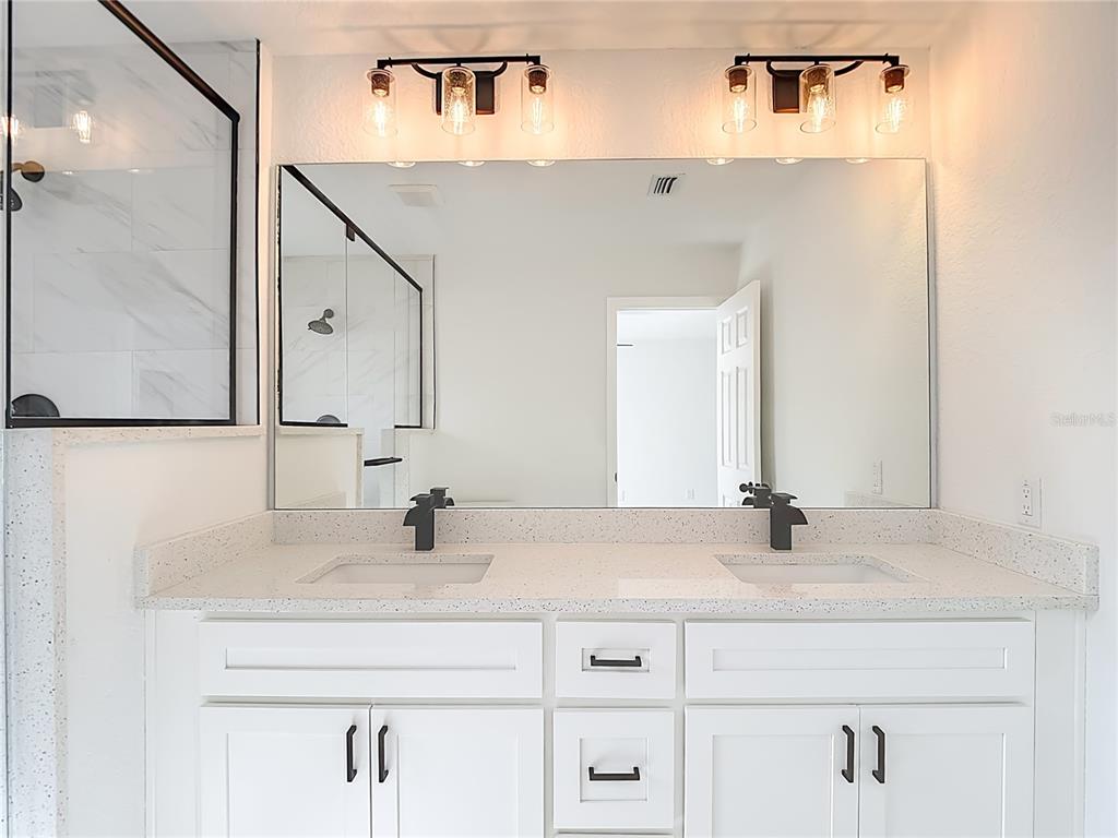 7478 Dundee Way Weeki Wachee, FL 34613 - Photo 32 of 52 a bathroom with a sink and a mirror