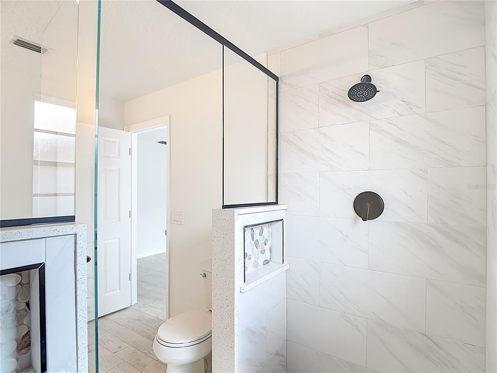 7478 Dundee Way Weeki Wachee, FL 34613 - Photo 35 of 52 a bathroom with a toilet a sink and shower