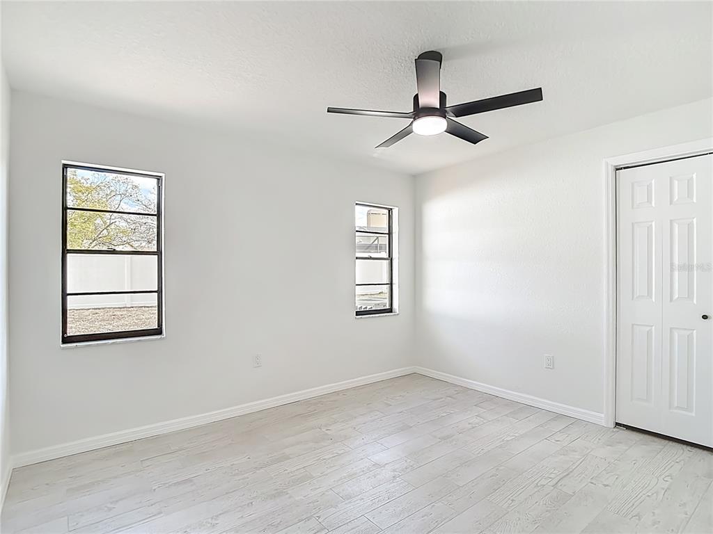 7478 Dundee Way Weeki Wachee, FL 34613 - Photo 37 of 52 an empty room with windows and fan