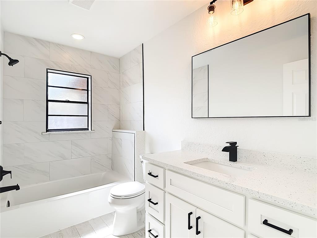 7478 Dundee Way Weeki Wachee, FL 34613 - Photo 39 of 52 a bathroom with a sink a toilet and shower