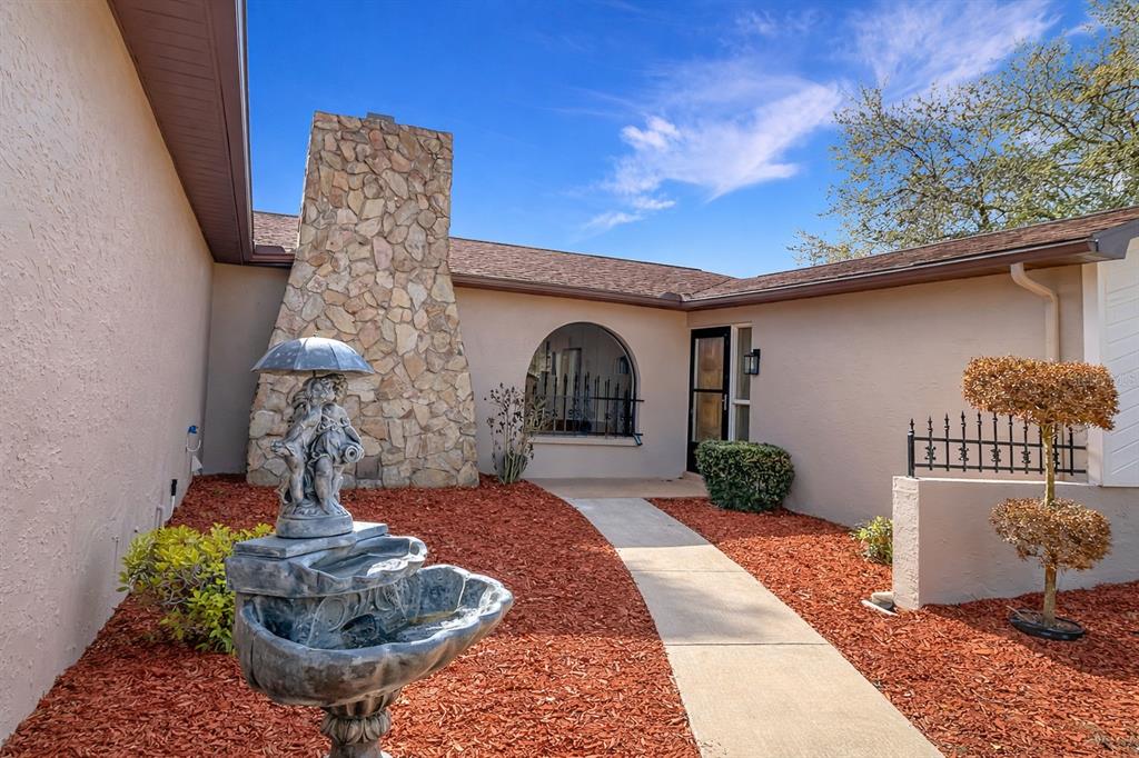 7478 Dundee Way Weeki Wachee, FL 34613 - Photo 4 of 52 a front view of a house with garden