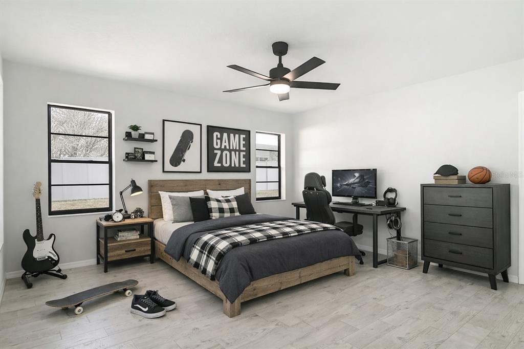 7478 Dundee Way Weeki Wachee, FL 34613 - Photo 41 of 52 a bedroom with a bed and a chandelier