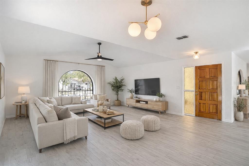 7478 Dundee Way Weeki Wachee, FL 34613 - Photo 7 of 52 a living room with furniture and a flat screen tv