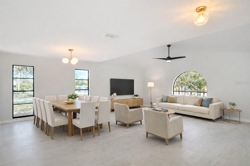 7478 Dundee Way Weeki Wachee, FL 34613 - Photo 8 of 52 a living room with furniture and a flat screen tv