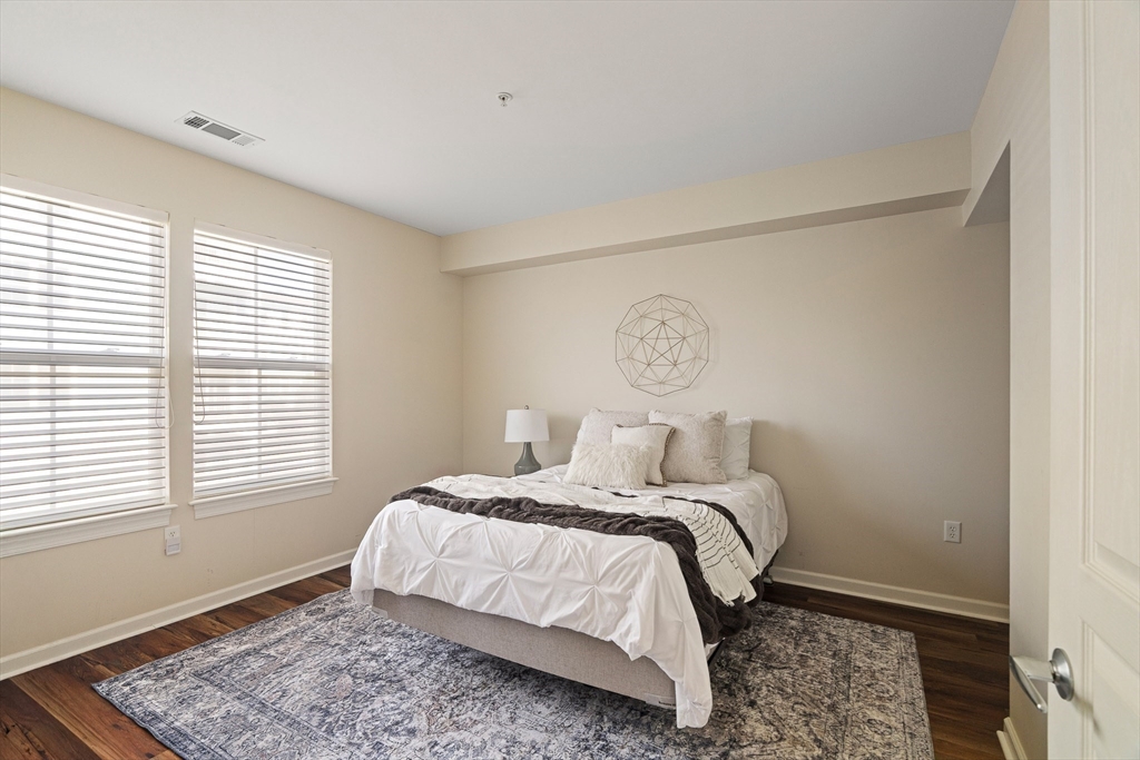 4 Repton Place, Unit 4213 Watertown, MA 02472 - Photo 12 of 19 a bedroom with a bed and a window