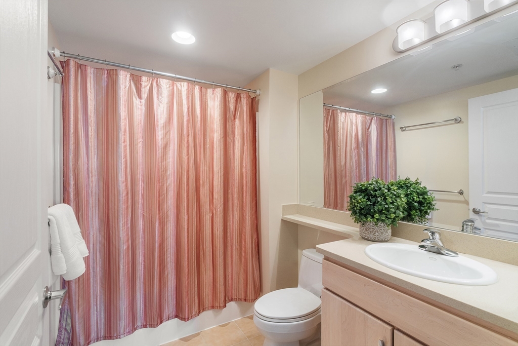4 Repton Place, Unit 4213 Watertown, MA 02472 - Photo 15 of 19 a bathroom with a sink toilet and shower