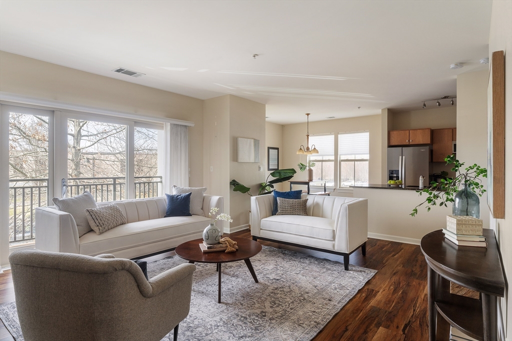4 Repton Place, Unit 4213 Watertown, MA 02472 - Photo 2 of 19 a living room with furniture wooden floor and a large window