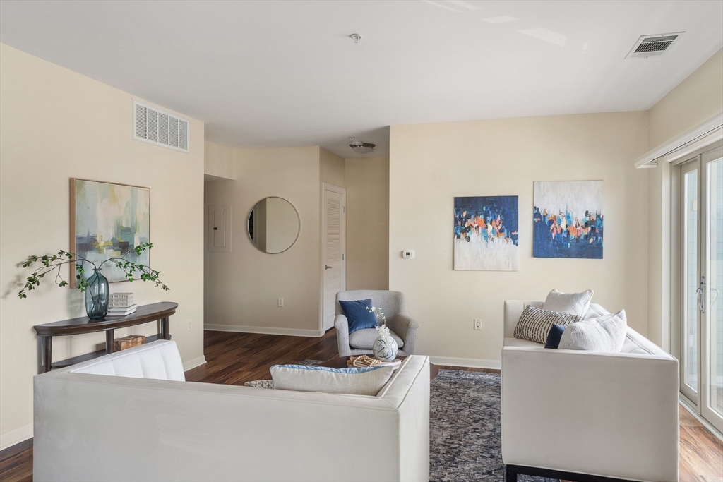 4 Repton Place, Unit 4213 Watertown, MA 02472 - Photo 5 of 19 a living room with furniture and a potted plant