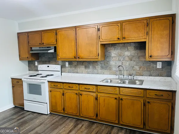 a kitchen with stainless steel appliances granite countertop a sink stove and microwave