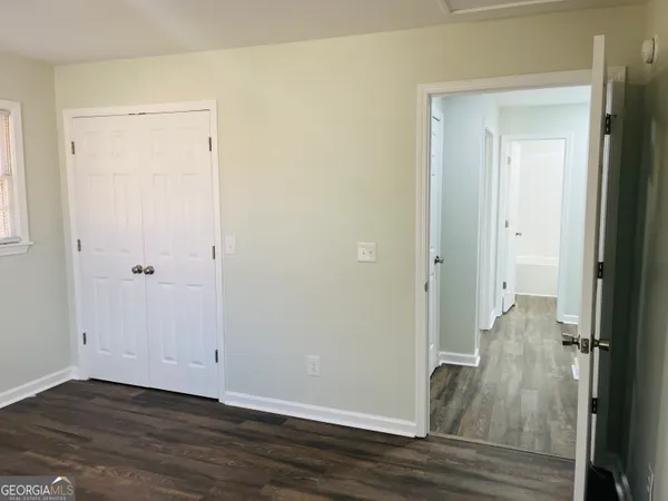 a view of a room with wooden floor